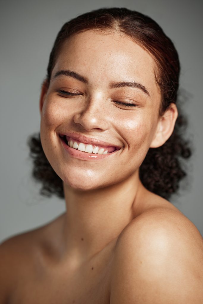 The Soft-Glam Aesthetic: How Subtle Enhancements Create a Naturally Beautiful Look Face, beauty and skincare with a model black woman in studio on a gray background to promote natural care. Facial, wellness and makeup with an attractive young female happy with her skin product