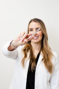 woman holding syringe with xeomin in it